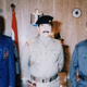 Uday (left) with his father, Saddam Hussein (center). Photo via Getty Images